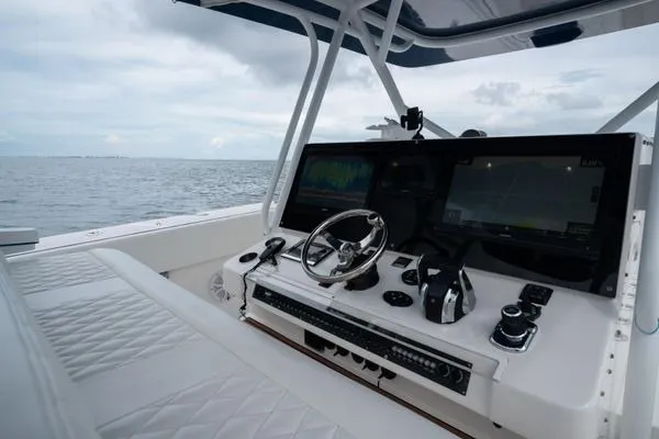 Slide: The Image of 2016 SeaHunter 45 Tournament boat cockpit with advanced navigation systems on open water. - 3