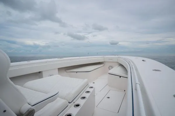 Slide: The Image of 2016 SeaHunter 45 Tournament boat deck with seating, under a cloudy sky. - 9