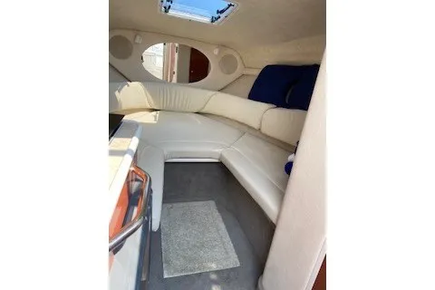 Slide: The Image of Interior of 2004 Sea Ray 240 Sundancer boat with beige seating and skylight. - 10