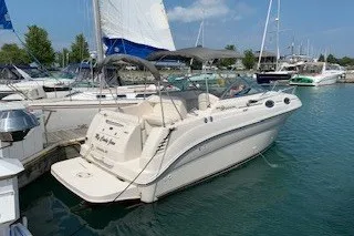 Slide: The Image of 2004 Sea Ray 240 Sundancer docked at marina, surrounded by sailboats. - 6