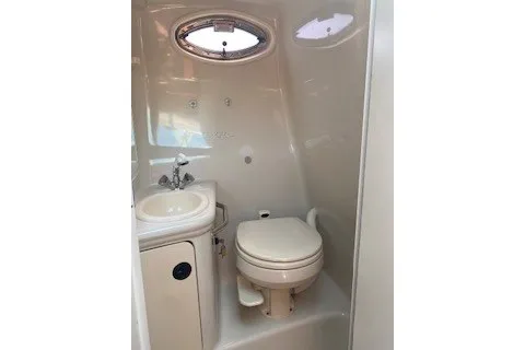 Slide: The Image of 2004 Sea Ray 240 Sundancer boat bathroom with sink and toilet. - 9