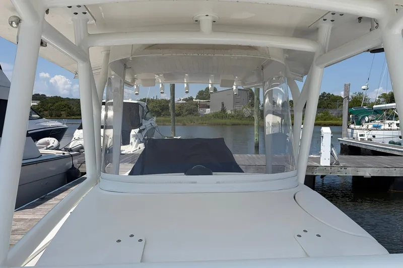 Slide: The Image of 2015 Regulator 34 Center Console boat docked at a marina. - 2