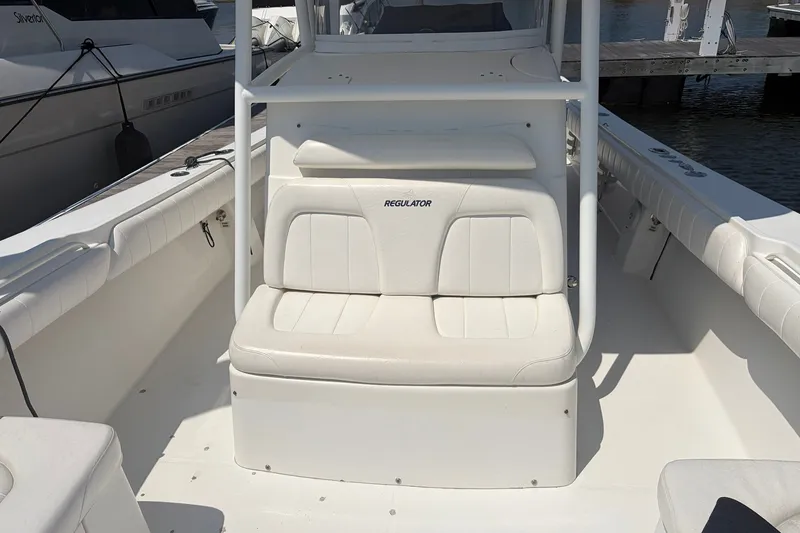 Slide: The Image of 2015 Regulator 34 Center Console boat interior with white seating and console. - 10