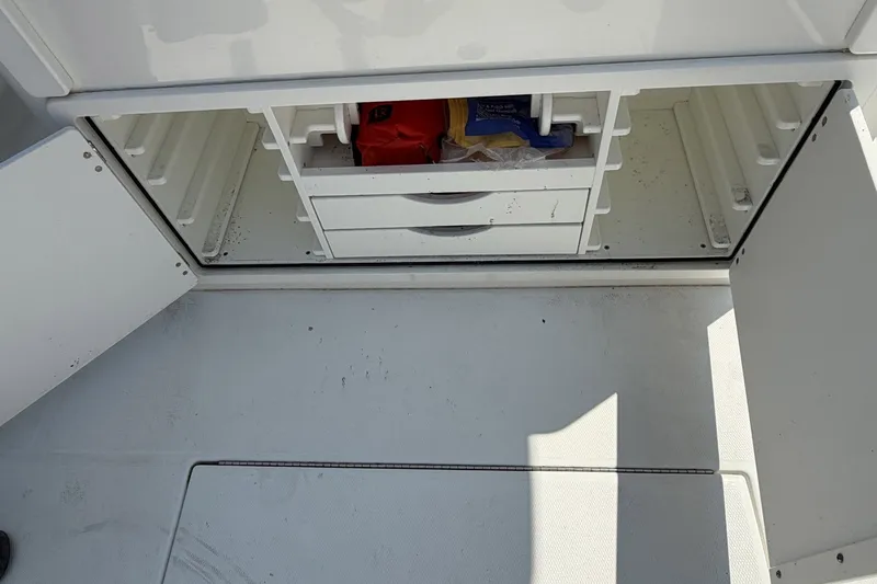 Slide: The Image of Open storage compartment on a 2015 Regulator 34 Center Console boat. - 8