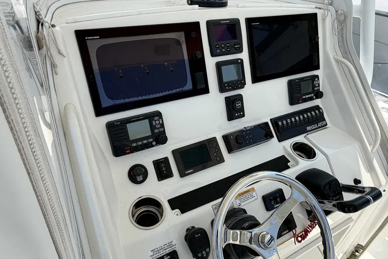 Slide: The Image of Control panel of a 2015 Regulator 34 Center Console boat with advanced navigation equipment. - 3