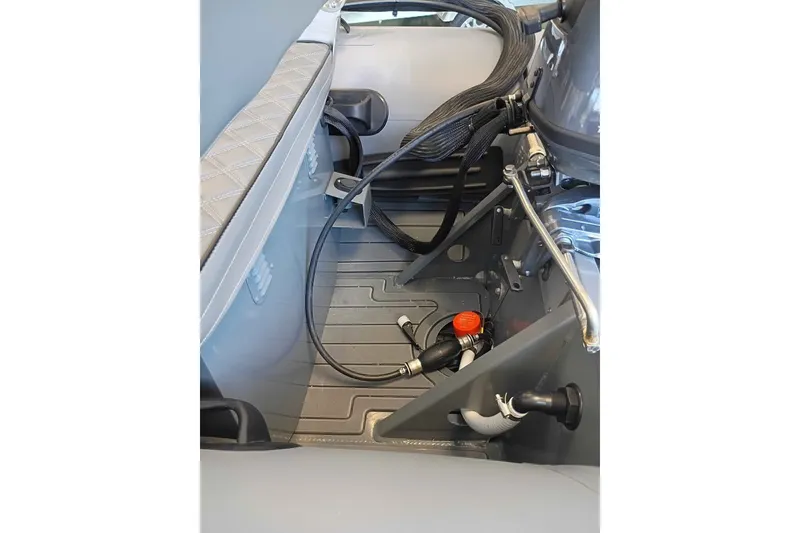 Slide: The Image of Interior view of 2026 DESNER ALUMINUM CL 310 boat, showcasing seating and engine components. - 5