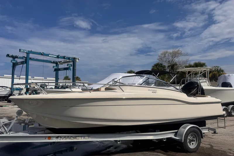 The Image of 2022 Scout 210 Dorado boat on trailer under clear blue sky. - 1