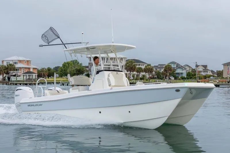 The Image of Manufacturer Provided Image: 2026 World Cat 235 HB boat cruising near waterfront homes. - 0