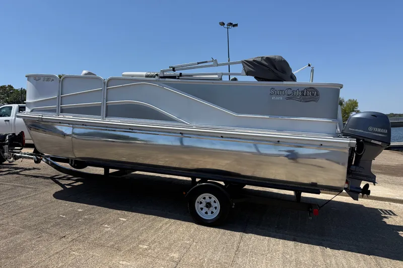 Slide: The Image of 2020 SunCatcher V18 Fish pontoon boat on trailer, featuring Yamaha outboard motor. - 12