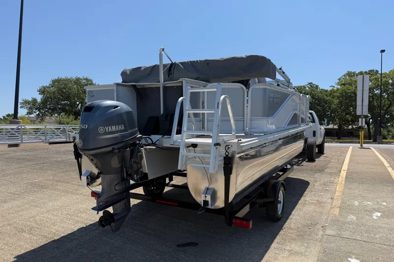 Slide: The Image of 2020 SunCatcher V18 Fish boat with Yamaha motor on trailer in sunny parking lot. - 7