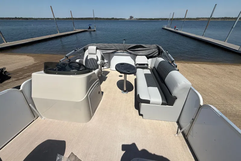 Slide: The Image of 2020 SunCatcher V18 Fish pontoon boat interior at a lakeside dock. - 25