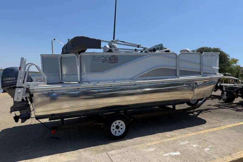 Slide: The Image of 2020 SunCatcher V18 Fish pontoon boat on trailer, featuring Yamaha outboard motor. - 4