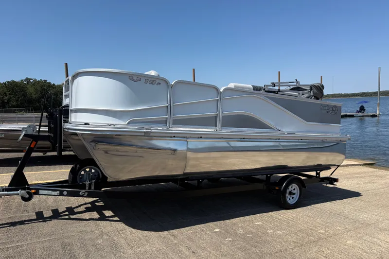Slide: The Image of 2020 SunCatcher V18 Fish pontoon boat on trailer by a lake. - 16