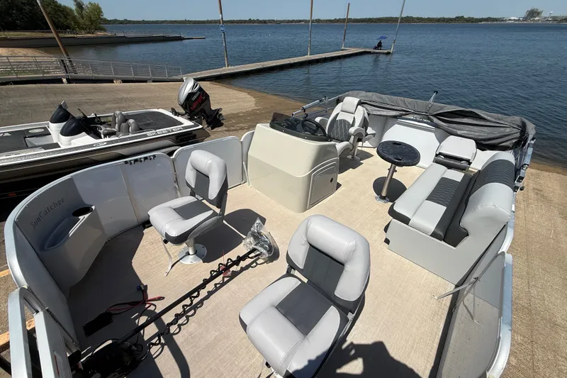 Slide: The Image of 2020 SunCatcher V18 Fish pontoon boat with spacious seating and fishing setup by the lake. - 23