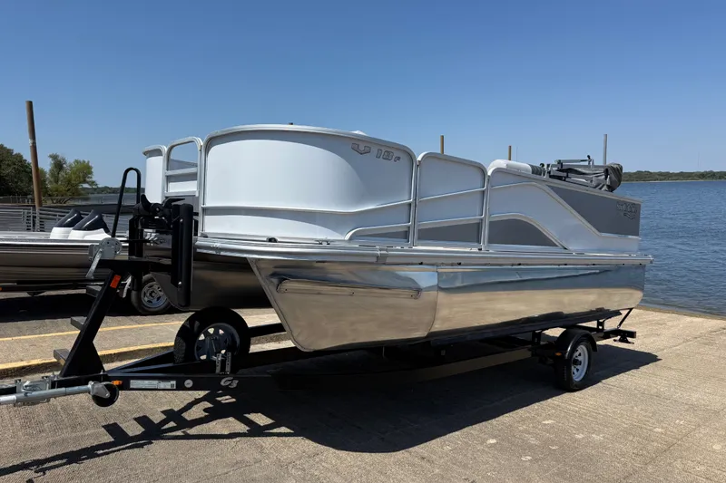 Slide: The Image of 2020 SunCatcher V18 Fish pontoon boat on trailer by the water. - 17