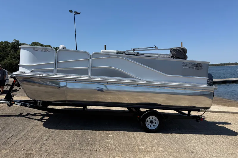 Slide: The Image of 2020 SunCatcher V18 Fish pontoon boat on trailer by a lake. - 14