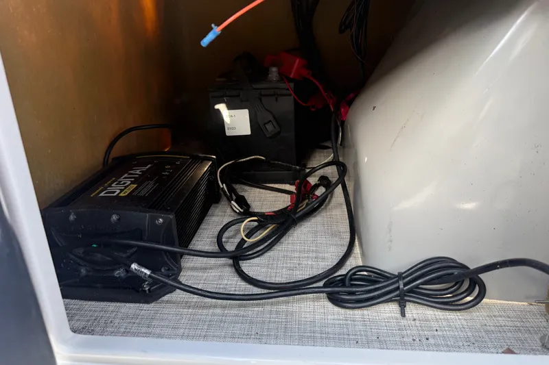 Slide: The Image of Battery and charger setup inside a 2020 SunCatcher V18 Fish boat compartment. - 45