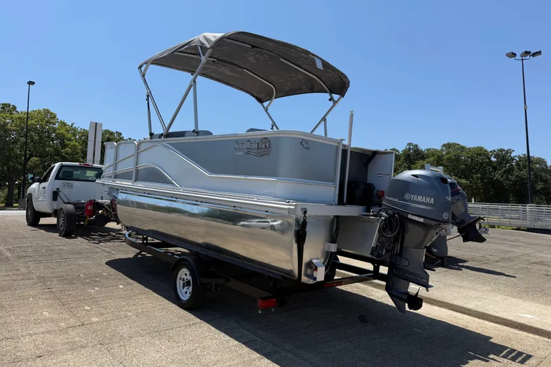 Slide: The Image of 2020 SunCatcher V18 Fish boat on trailer with Yamaha motor, parked outdoors. - 30