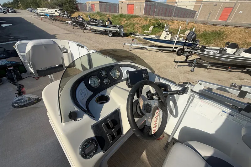 Slide: The Image of 2020 SunCatcher V18 Fish boat dashboard with steering wheel and control panel. - 39