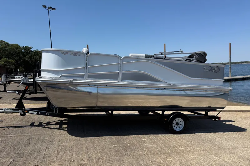 Slide: The Image of 2020 SunCatcher V18 Fish pontoon boat on trailer by a lake. - 15