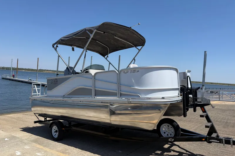 Slide: The Image of 2020 SunCatcher V18 Fish pontoon boat on trailer by the lake. - 27