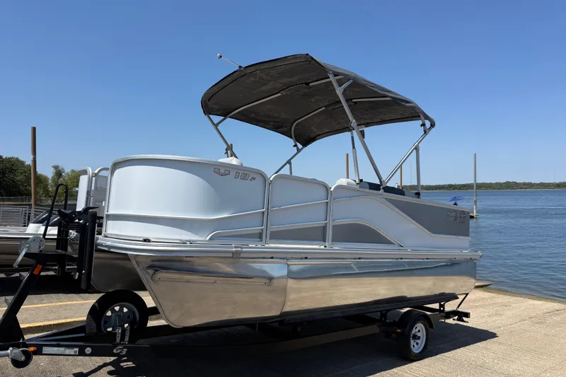 Slide: The Image of 2020 SunCatcher V18 Fish pontoon boat on trailer by a lake. - 33