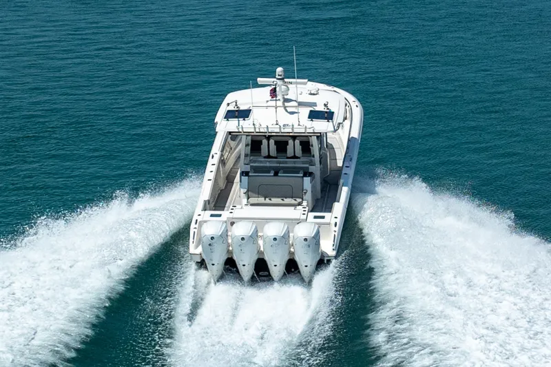 Slide: The Image of 2022 Pursuit S 428 Sport boat cruising on open water, rear view. - 22