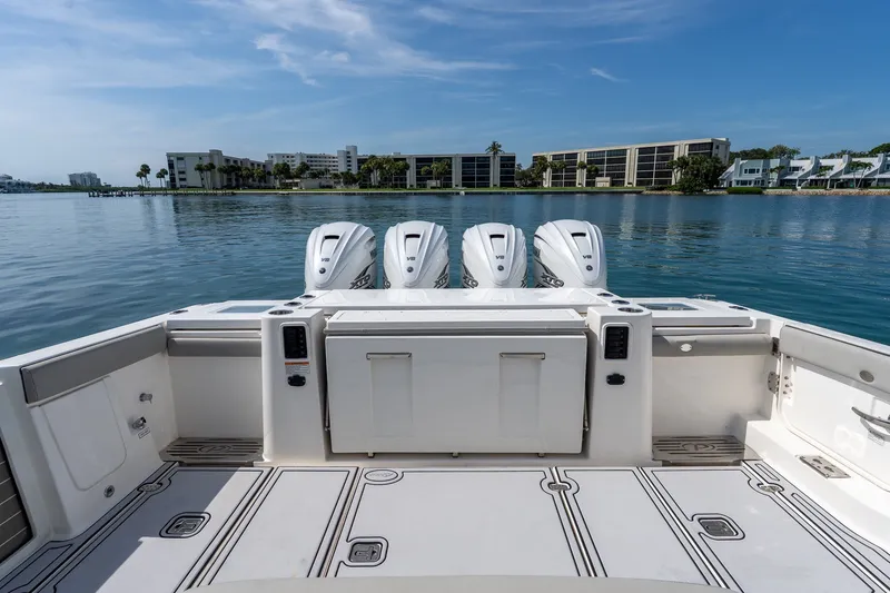Slide: The Image of 2022 Pursuit S 428 Sport boat with four engines on calm water. - 31
