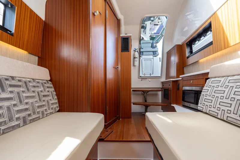 Slide: The Image of Interior of 2022 Pursuit S 428 Sport boat with modern seating and wood finishes. - 46