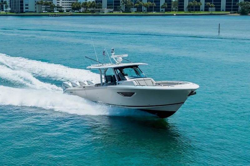 Slide: The Image of 2022 Pursuit S 428 Sport boat cruising on clear blue water. - 23