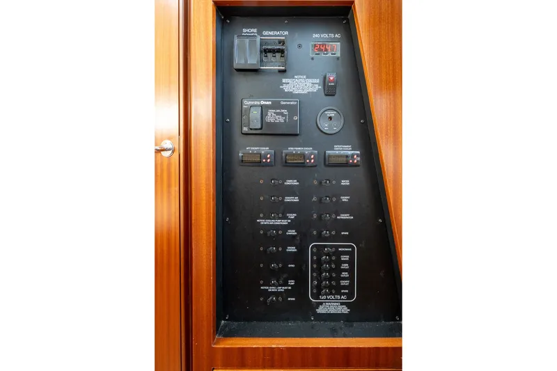 Slide: The Image of Electrical control panel on 2022 Pursuit S 428 Sport boat, featuring various switches and indicators. - 49