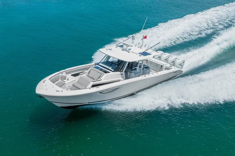Slide: The Image of 2022 Pursuit S 428 Sport boat cruising on clear blue water. - 25