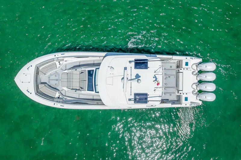Slide: The Image of Aerial view of 2022 Pursuit S 428 Sport boat on clear turquoise water. - 16