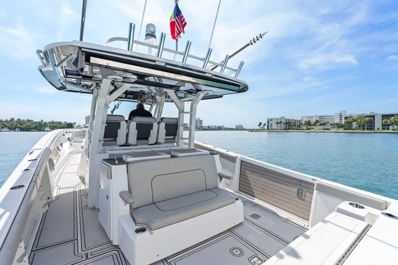 Slide: The Image of 2022 Pursuit S 428 Sport boat on calm water, featuring spacious seating and modern design. - 28