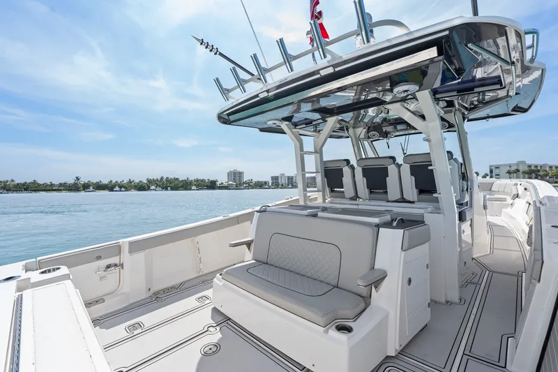 Slide: The Image of 2022 Pursuit S 428 Sport boat with spacious seating and sleek design on calm waters. - 29