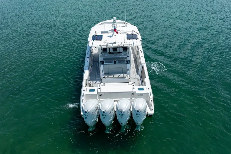 Slide: The Image of 2022 Pursuit S 428 Sport boat with four engines on open water. - 13
