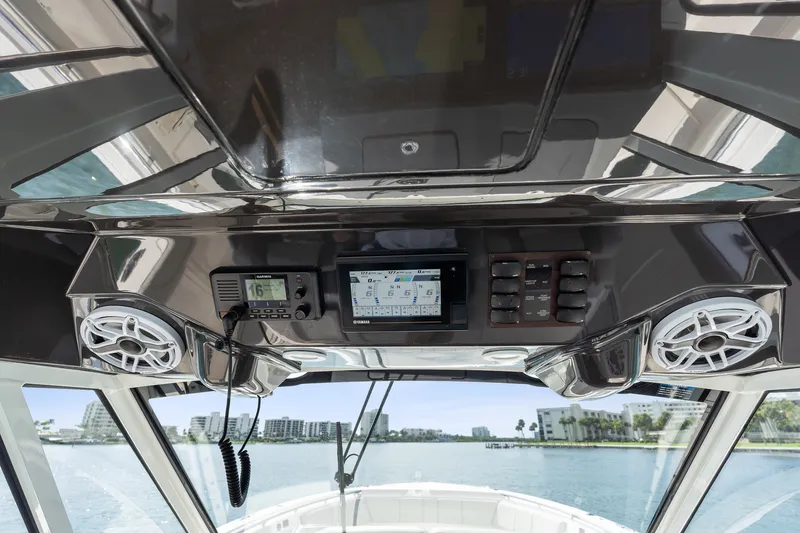 Slide: The Image of 2022 Pursuit S 428 Sport boat dashboard with navigation and communication systems. - 42
