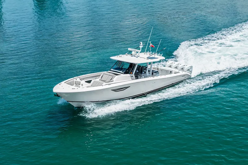 The Image of 2022 Pursuit S 428 Sport boat cruising on clear blue water. - 0