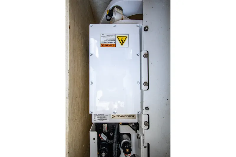 Slide: The Image of Seakeeper system in 2022 Pursuit S 428 Sport boat, featuring electrical warning label. - 55