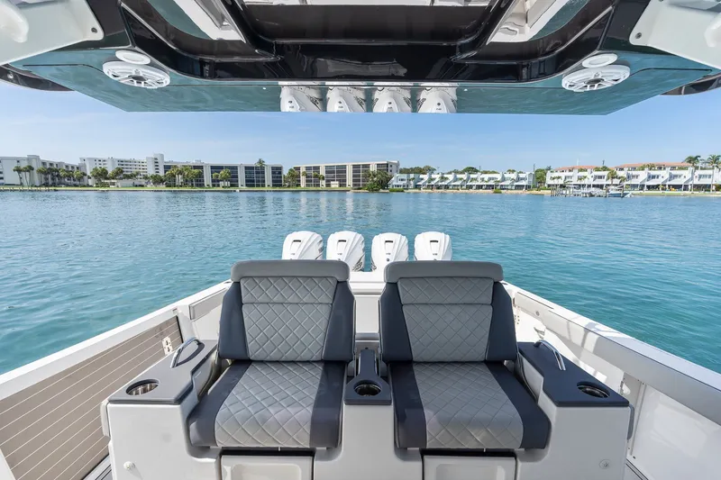Slide: The Image of 2022 Pursuit S 428 Sport boat interior with luxurious seating on calm water. - 34
