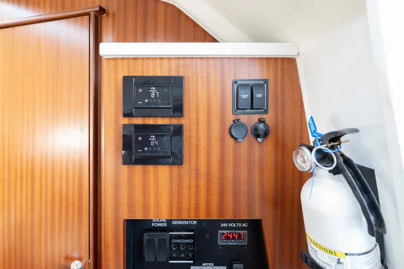 Slide: The Image of Control panel on 2022 Pursuit S 428 Sport boat with fire extinguisher and digital displays. - 48
