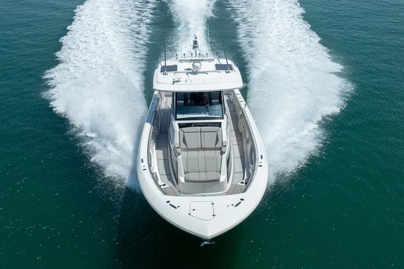 Slide: The Image of 2022 Pursuit S 428 Sport boat cruising on open water, aerial view. - 24