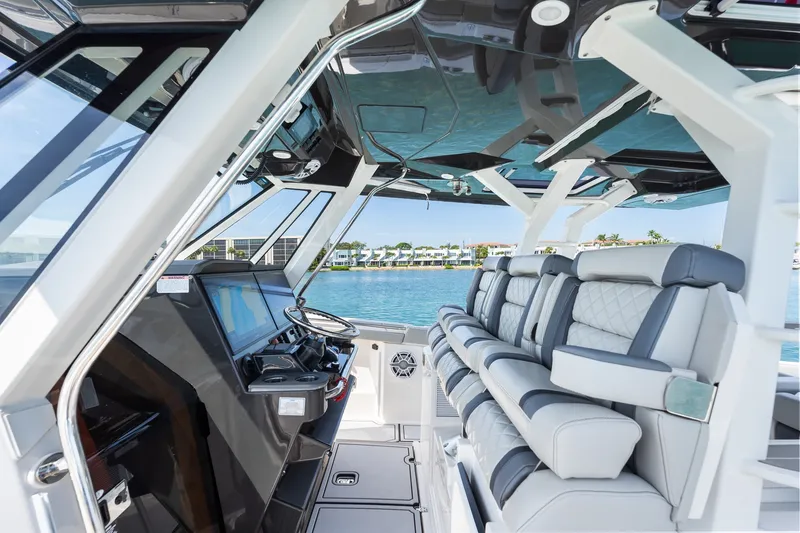 Slide: The Image of Interior of 2022 Pursuit S 428 Sport boat with luxurious seating and modern dashboard. - 38