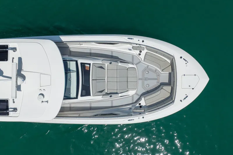 Slide: The Image of Overhead view of 2022 Pursuit S 428 Sport boat on clear water. - 15