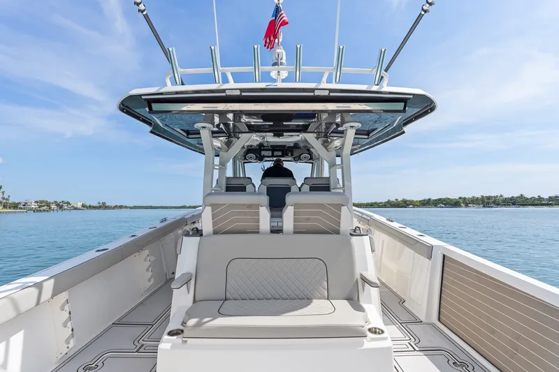 Slide: The Image of 2022 Pursuit S 428 Sport boat on calm water, featuring spacious seating and sleek design. - 33