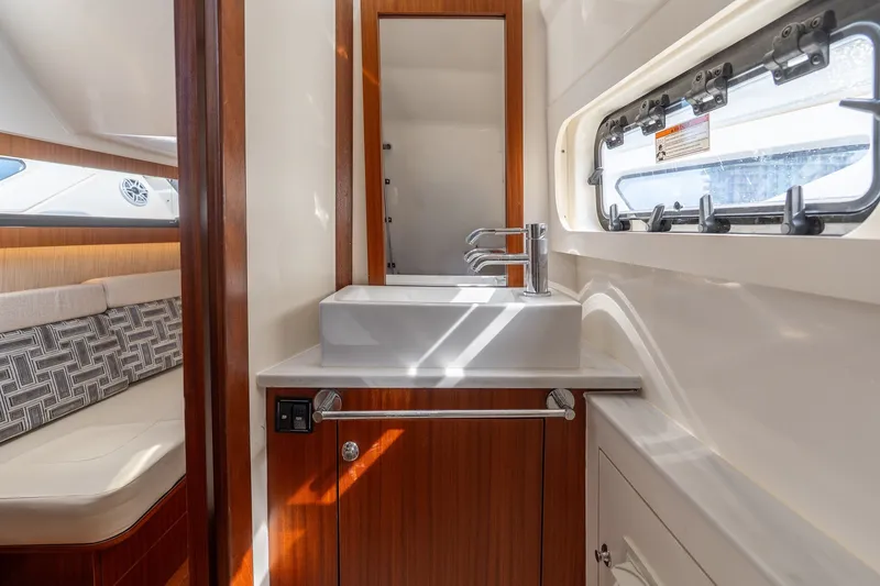 Slide: The Image of 2022 Pursuit S 428 Sport yacht interior with modern sink and seating area. - 51