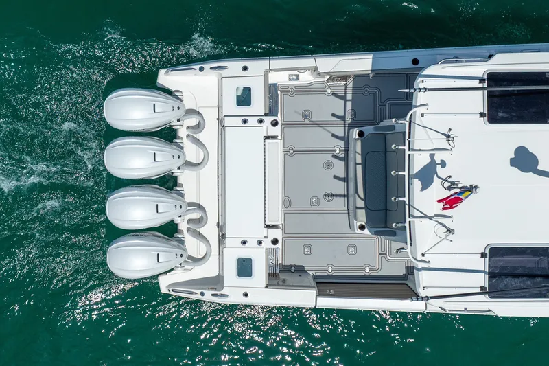 Slide: The Image of Overhead view of 2022 Pursuit S 428 Sport boat with four engines on turquoise water. - 14