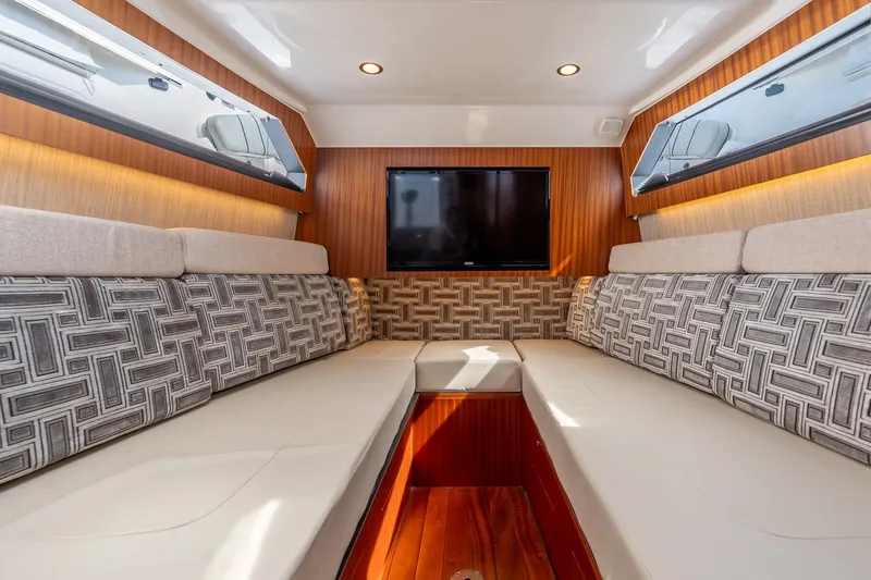 Slide: The Image of Luxurious interior of 2022 Pursuit S 428 Sport boat with plush seating and TV. - 50