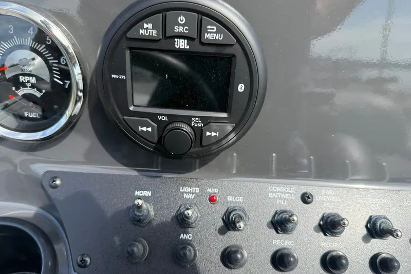 Slide: The Image of Dashboard of 2026 Avid 20 Rogue CC with JBL audio controls and switches. - 18