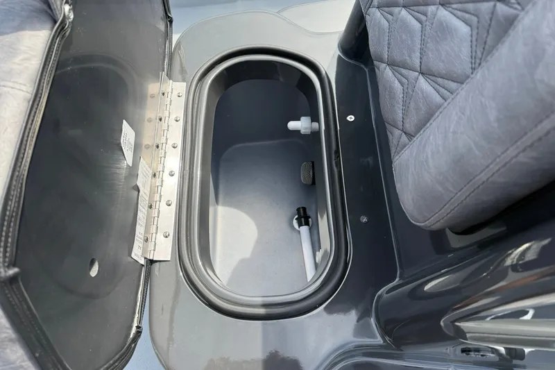 Slide: The Image of Open storage compartment in 2026 Avid 20 Rogue CC boat with gray seating. - 20